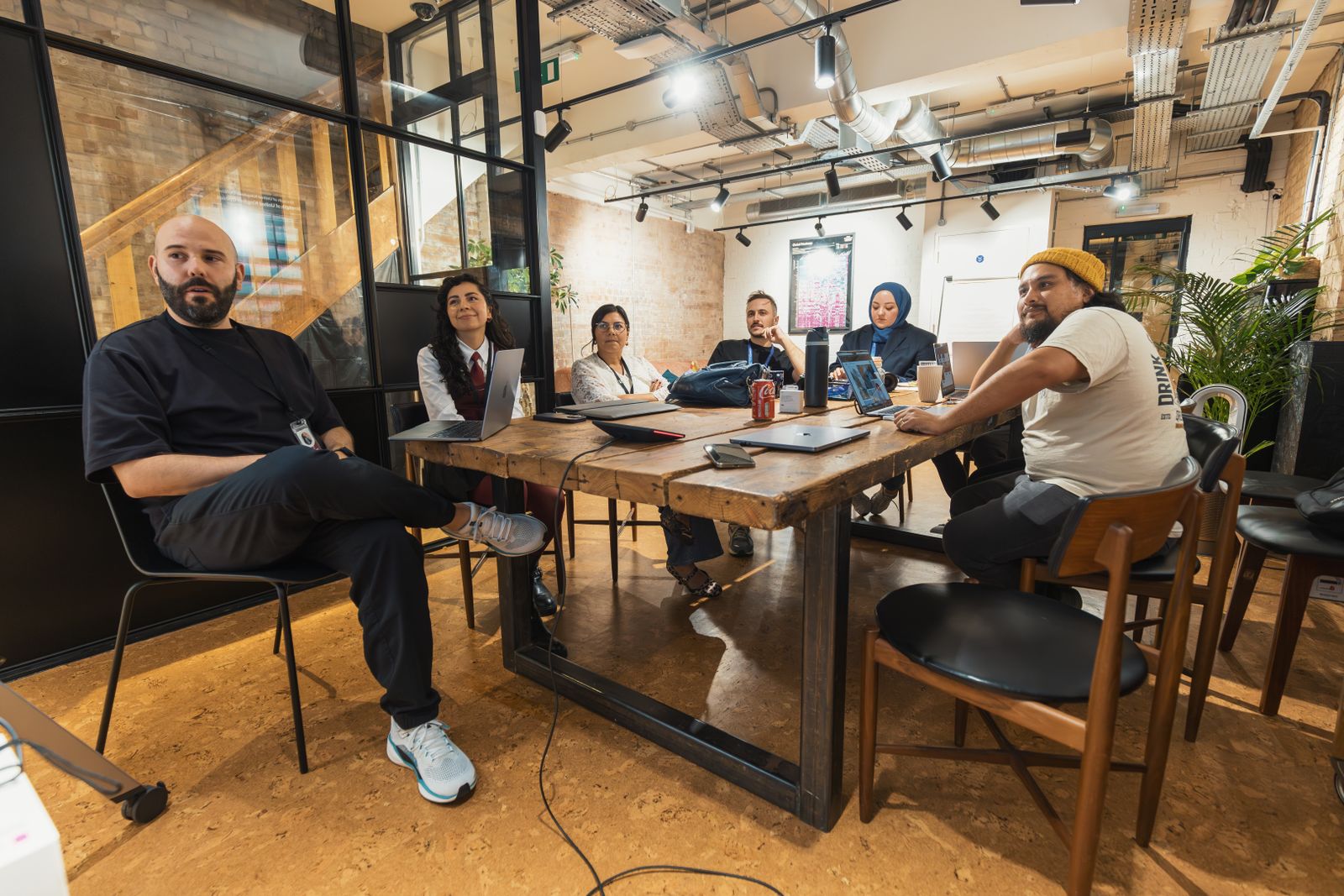 The team in a planning session around the studio table