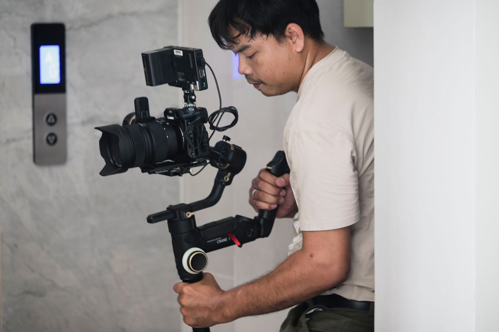 Videographer filming with a stabilizer indoors